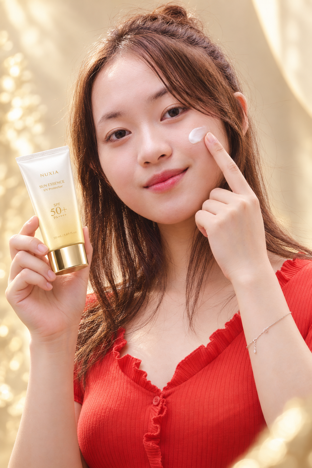 NUXIA model applying Sun Essence UV Protector to her cheek
